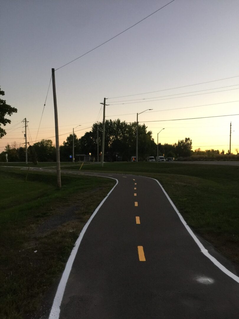 A picture of white and yellow line painting on the side road