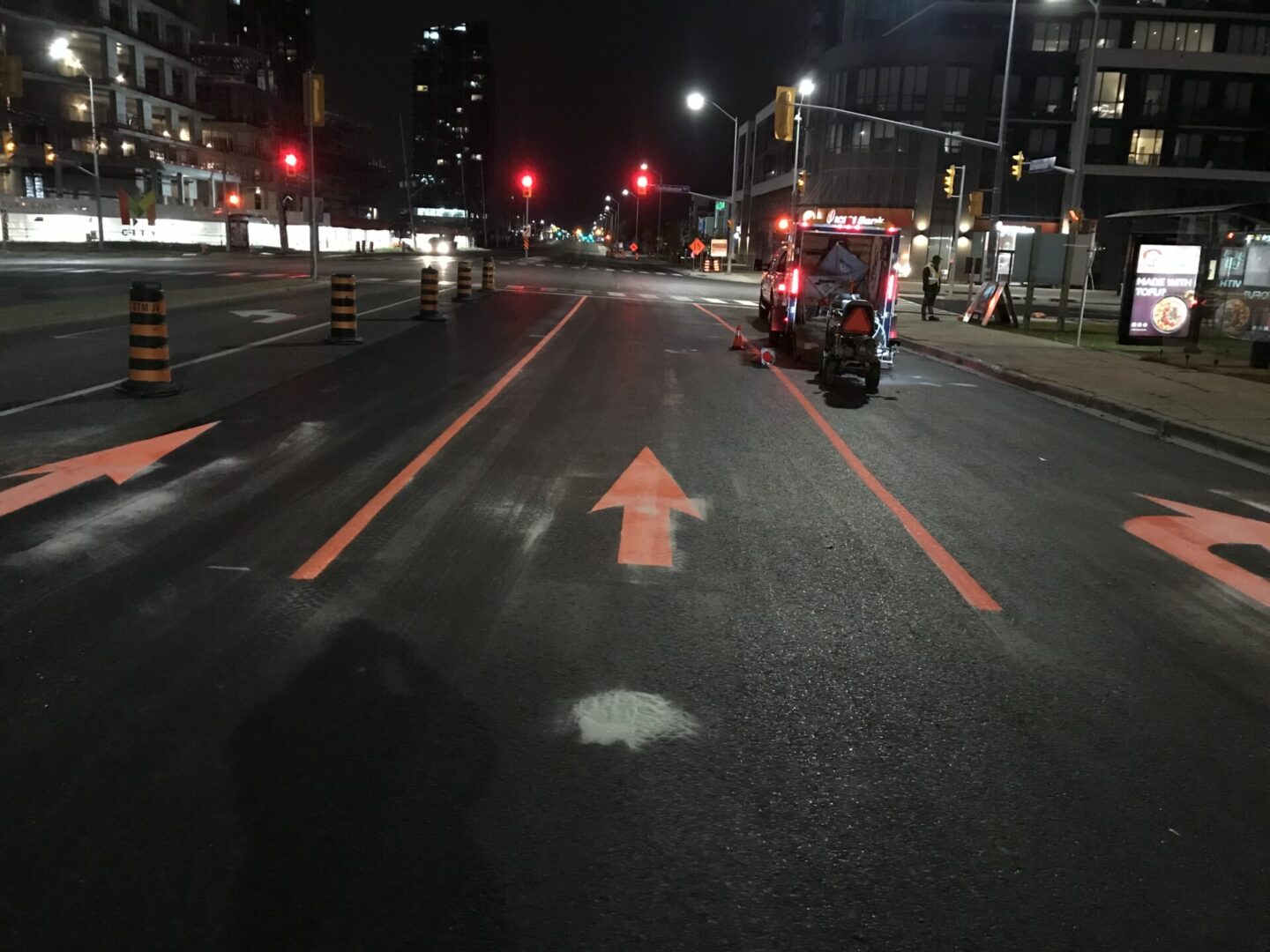 A picture of the orange color arrow markings on the road