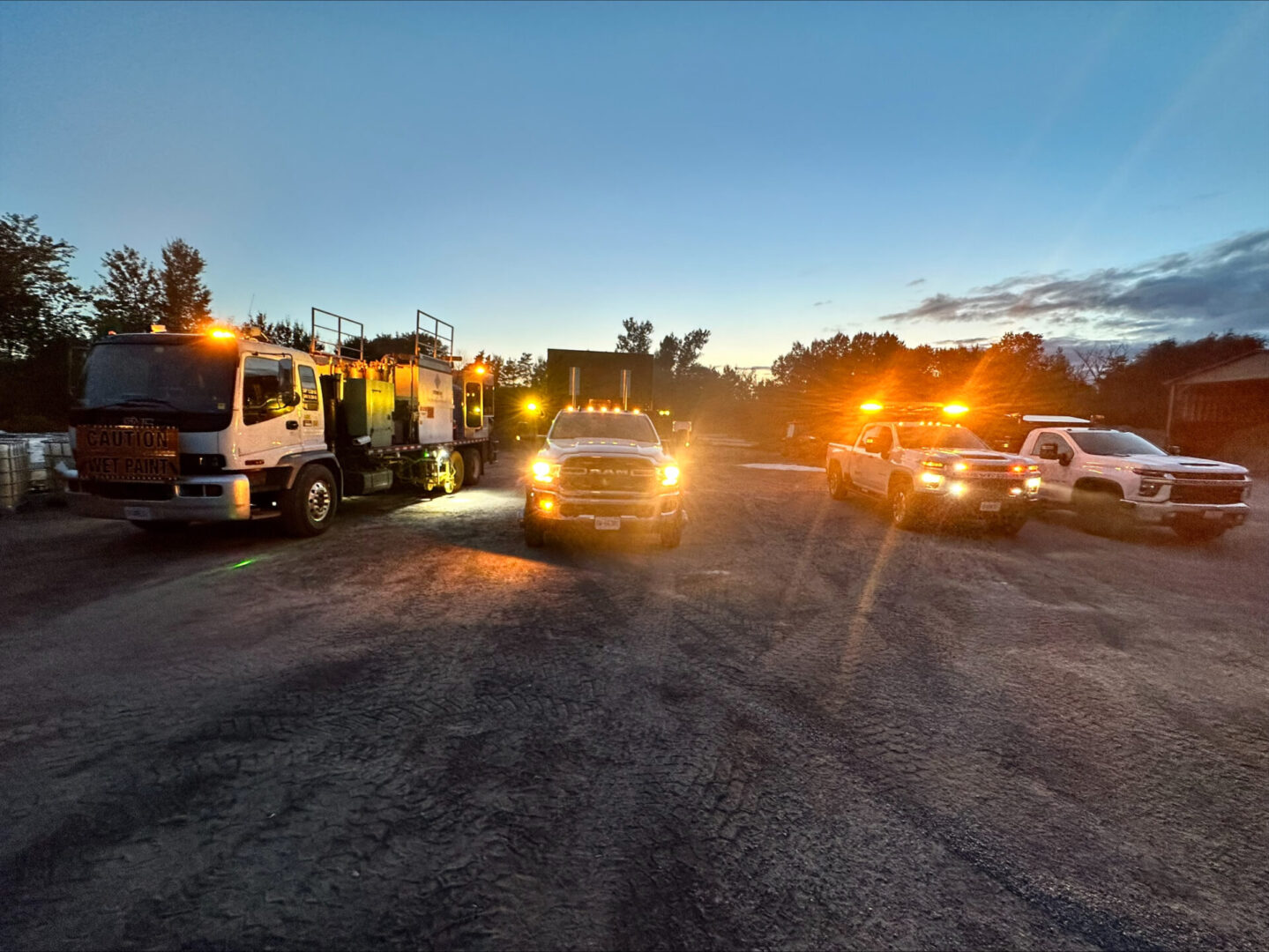 A bunch of trucks with their lights on